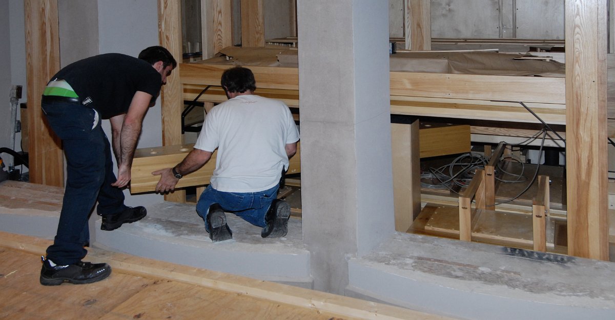 DSC_5655.JPG - Squeezing in the wind chest for the facade pipes on the lectern side...another tight fit.
